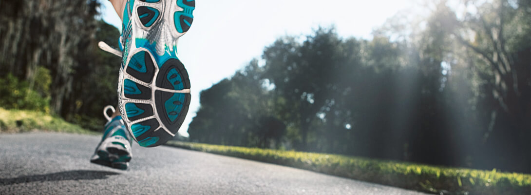 View from a street shows running shoes from behind