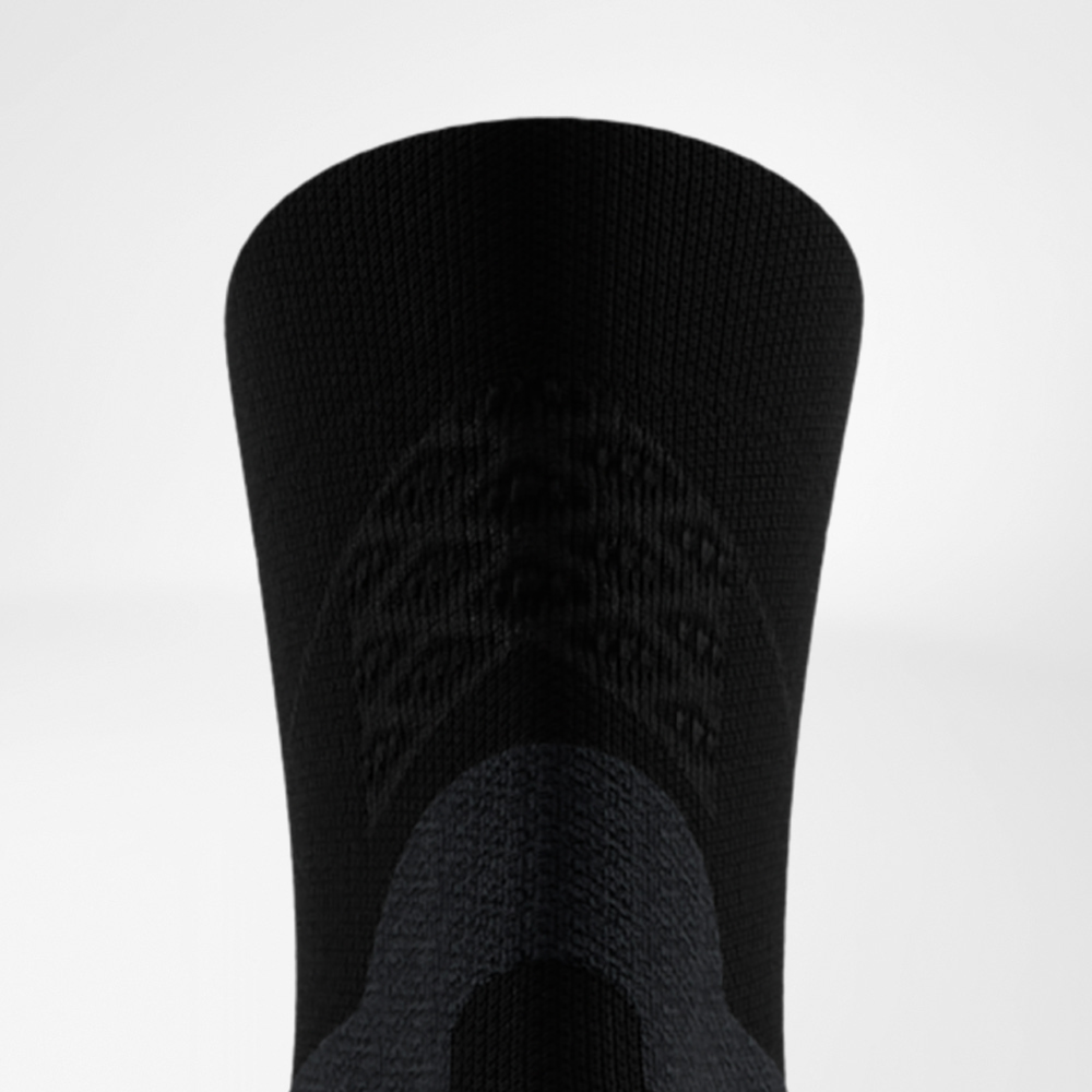 Close-up of the upper cuff of a black Bauerfeind Run Performance Midcut Sock with integrated stabilizing texture.