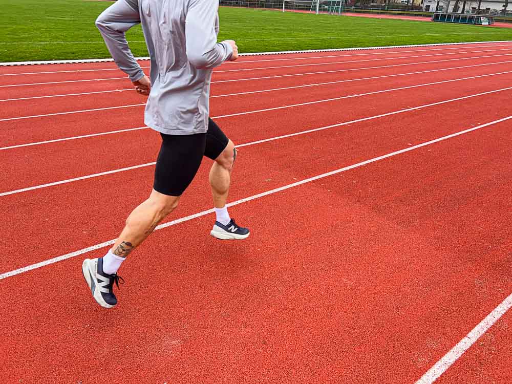 An athlete running on a track — ideal for HYROX training at home without a gym: intervals, tempo runs and endurance work can be done outside anytime.