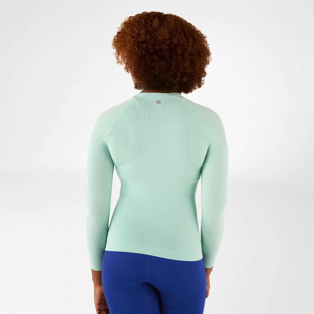 Back view of a light green, close-fitting long sleeve shirt with textured design