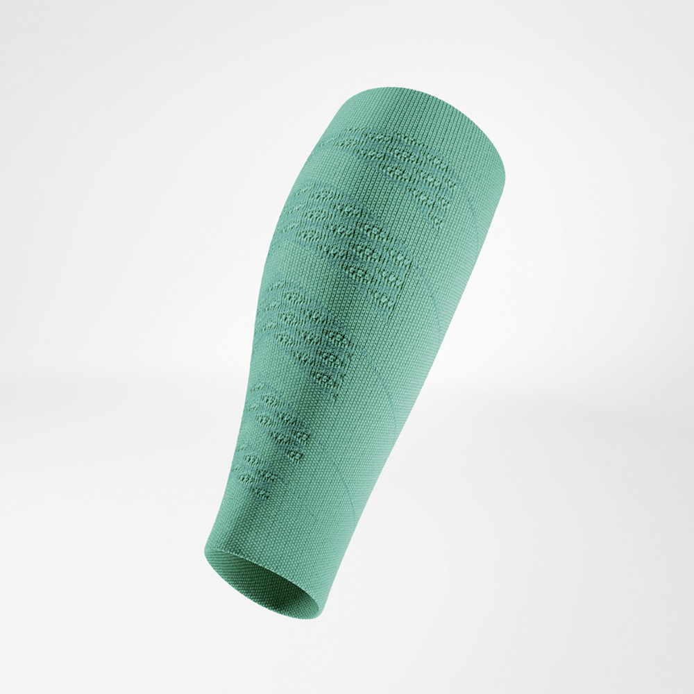 Green compression sleeve in angled side view, floating freely. The close-knit fabric features distinct textured zones designed for stability and ventilation.