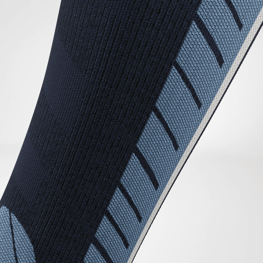 Close-up of the calf of a blue ski compression sock with a detailed knit pattern for enhanced breathability and support. Ideal for long days on the slopes.