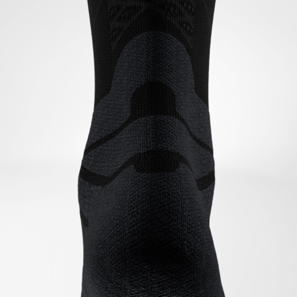 Close-up view of the black Run Performance Midcut Sock featuring the Achilles tendon comfort zone. The fine ribbed knit around the midfoot highlights breathability and secure support.