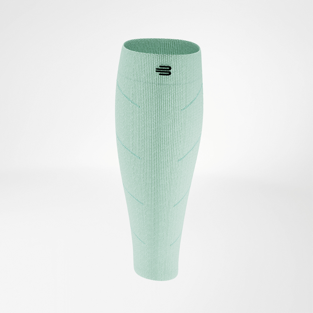 Close-up of a light green calf compression sleeve, displayed on a plain background. The seamless knit texture and small logo at the top are visible. The lightweight fabric looks breathable and provides targeted compression for running performance.