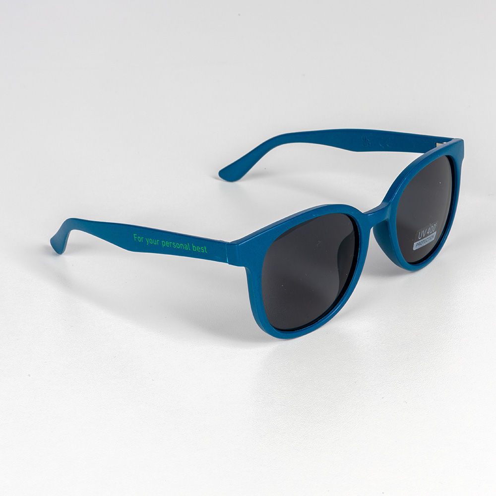 Teal sunglasses with dark lenses and the slogan “For your personal best” printed on the temple. Set against a white background.