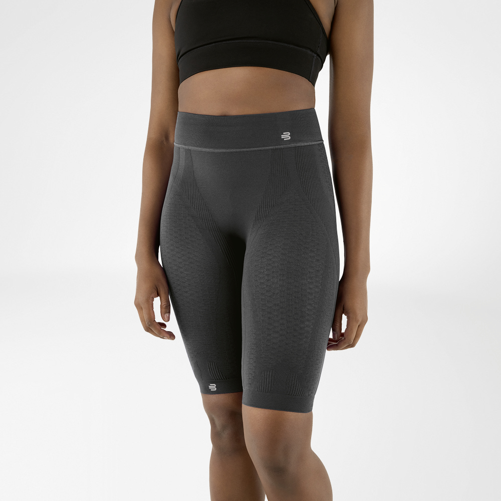 Lower body of a woman wearing knee-length, anthracite-coloured sports trousers