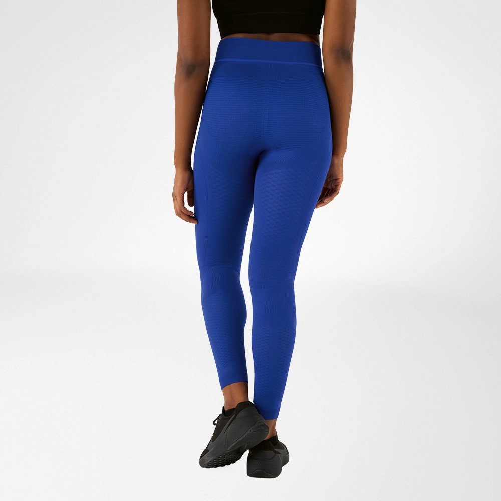 A woman photographed from behind in navy blue compression trousers.