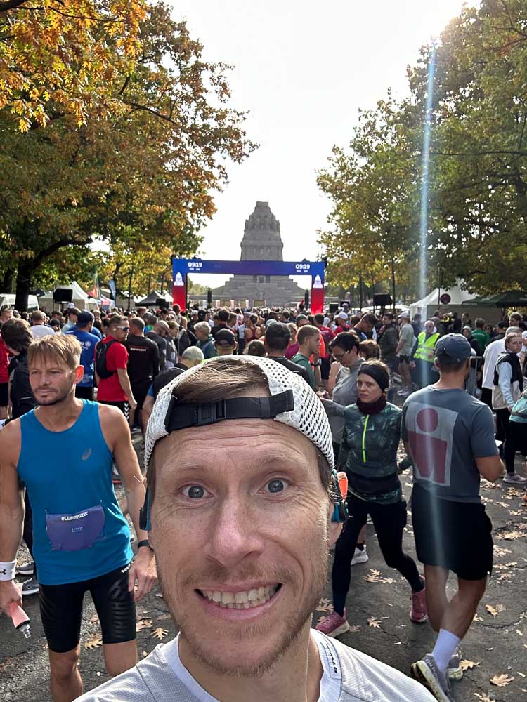 Runner takes a selfie in the crowded starting area before a half marathon