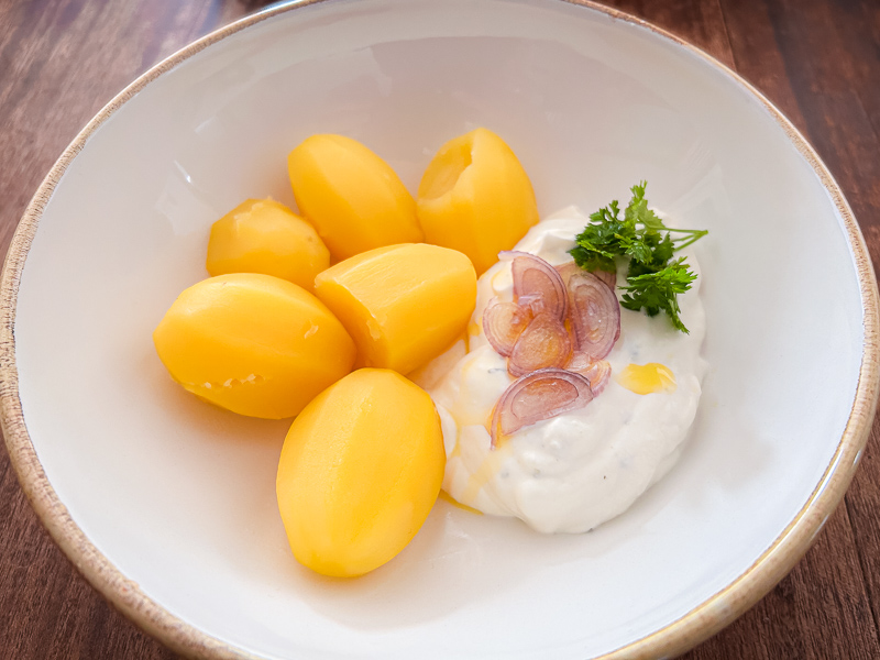 A plate of boiled potatoes and cottage cheese, a healthy and easily digestible meal for carbo-loading before a half marathon.