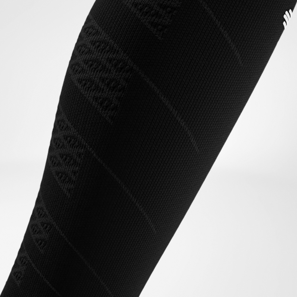 Close-up of a black Run Performance Compression Sleeve on the lower leg, showing the fine knit structure that provides targeted compression and supports the calf muscles while running.