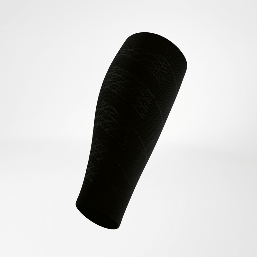 Black calf compression sleeve in a side view with a white logo on the upper edge. The smooth structure is accented by subtle knit lines following the leg’s contour.