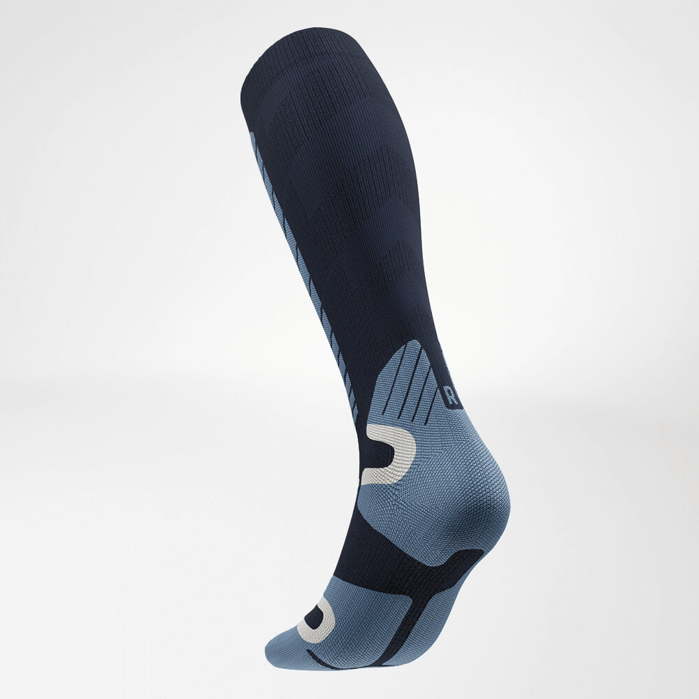 Angled rear view of a blue ski compression sock featuring ergonomic design and reinforced zones for enhanced stability and comfort during winter sports.