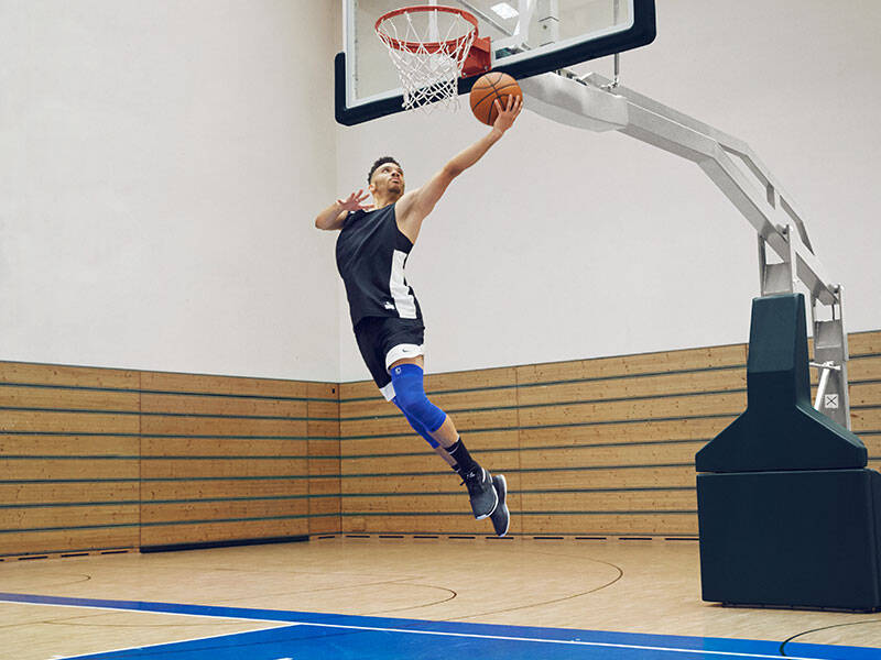 Corbleger of basketball players with blue compression knee support NBA