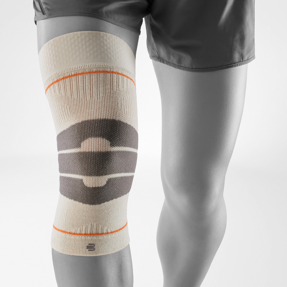 Sand-colored knee support for outdoor use, worn on the leg, ensures stability, secure fit, and comfortable support during activity.