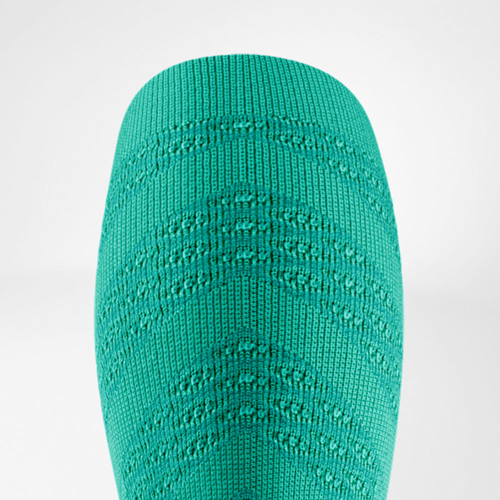Detailed view of a bright green compression sleeve with a clearly defined textured pattern. The material looks dynamic, conveying stability and energy for intense workouts.