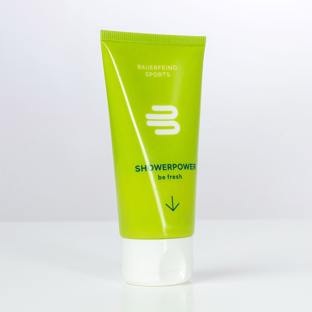 Studio shot of the green Bauerfeind Sports "ShowerPower" shower gel tube with the slogan "be fresh" on a white background.
