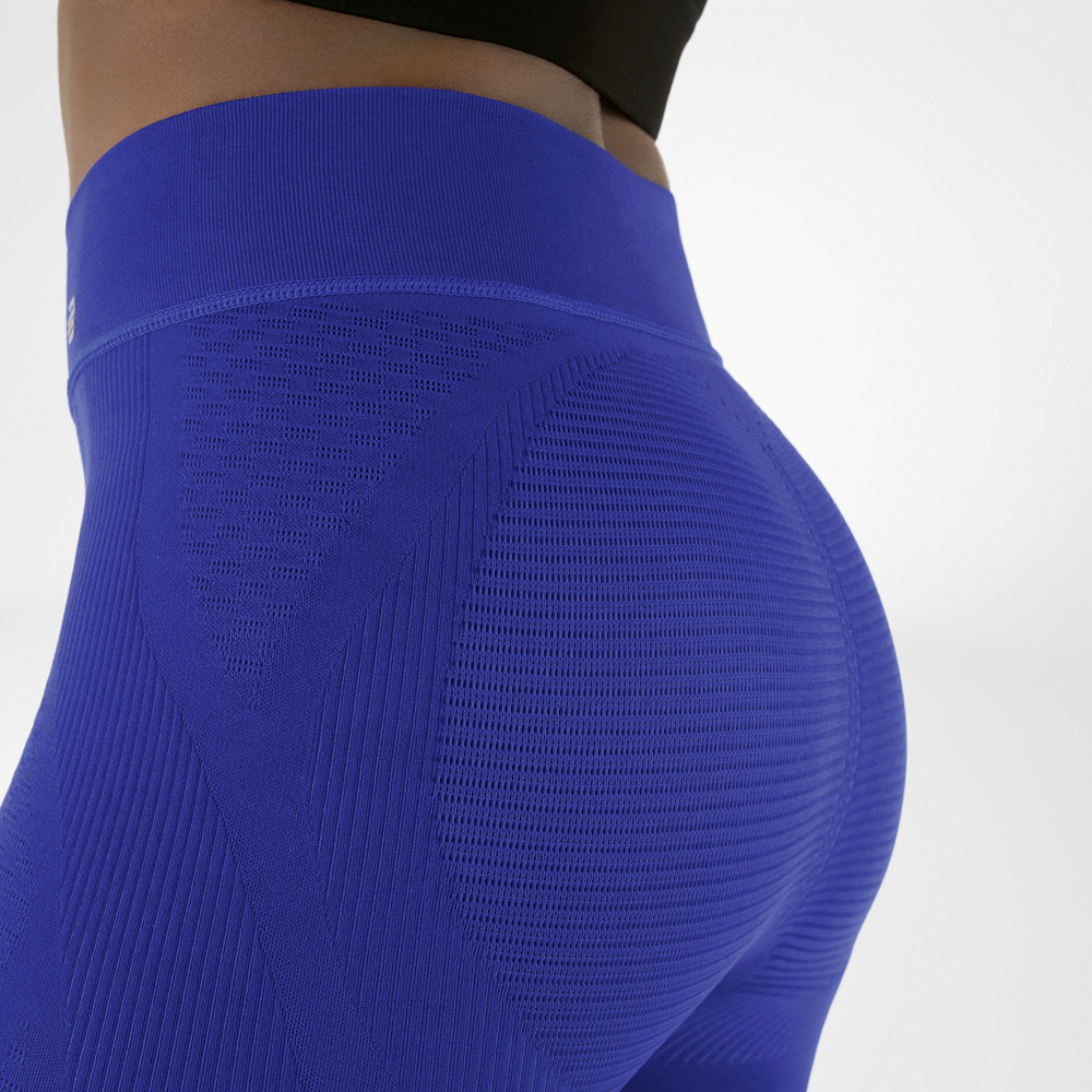 Waist cut-out of a picture of a woman wearing navy blue high waist compression trousers