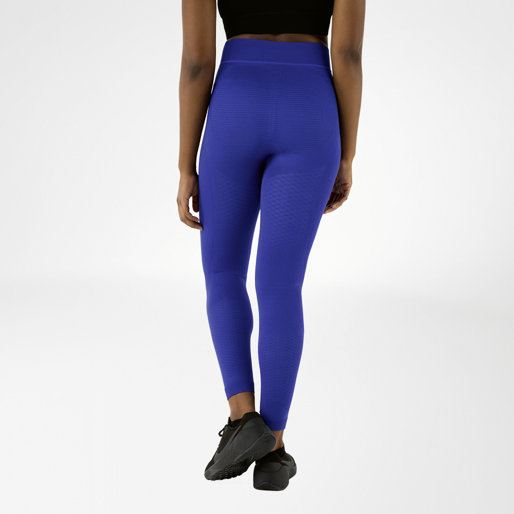 A woman photographed from behind in navy blue compression trousers.