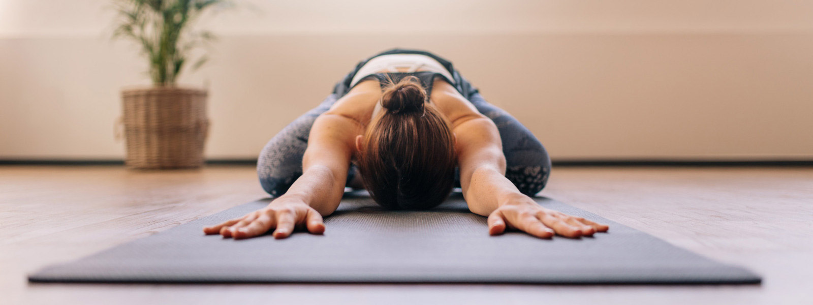 Deep -relaxed woman has put her head back between her arms on the mat