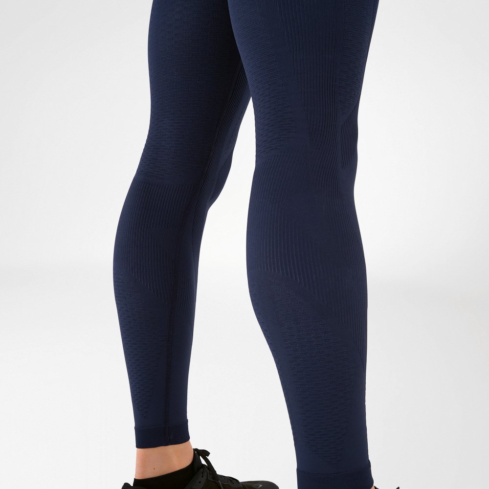 Calves of a man wearing dark blue compression trousers
