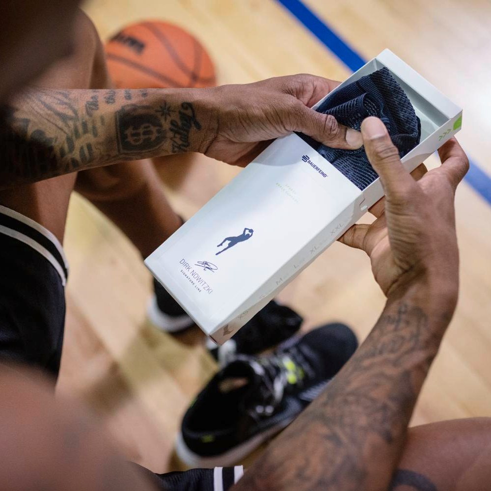 Unbox, wear, perform! An athlete opens a box containing the Dirk Nowitzki Special Edition ankle support.