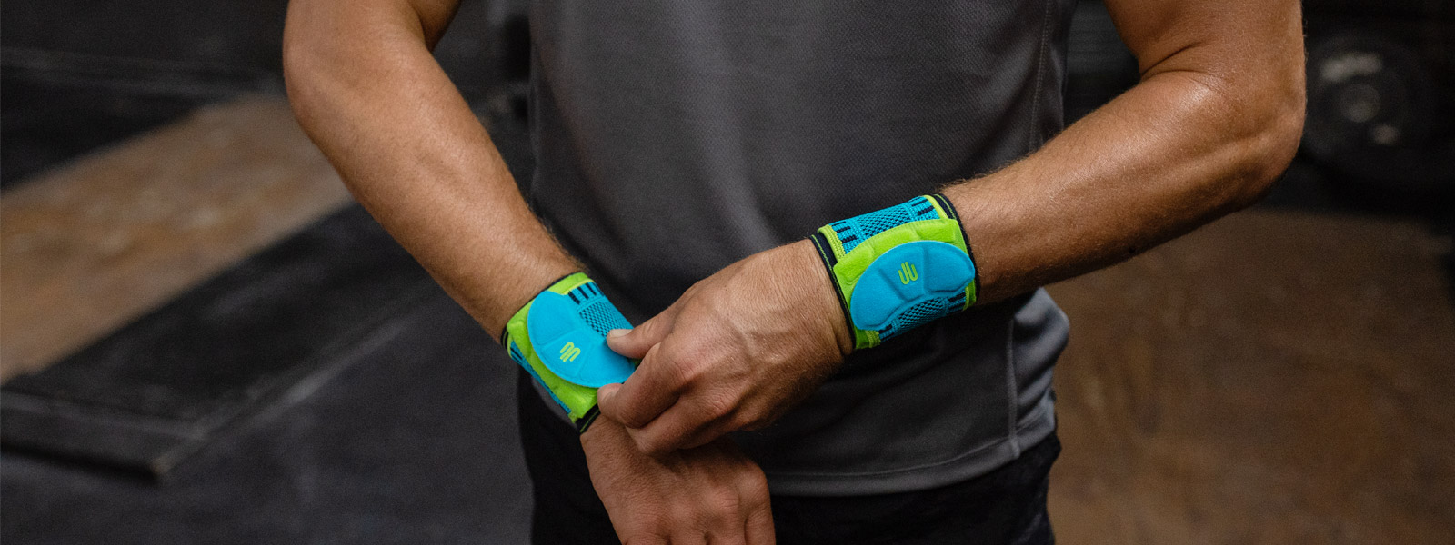 Sits as you want: the Sports Wrist Strap with individually adjustable belt Man in the fitness room rightly pulls one of his wrist bandages