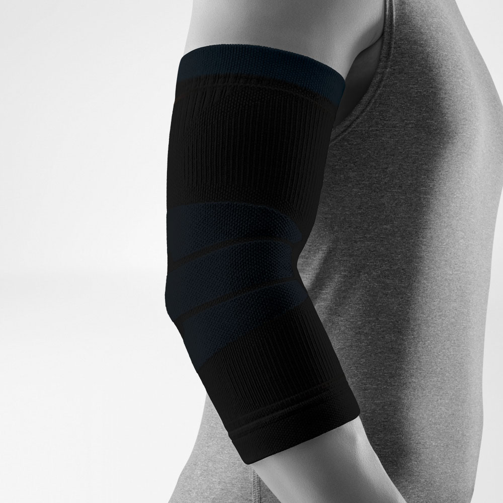 Studio image of a black Outdoor Compression Elbow Support worn on a slightly bent arm. The compression sleeve evenly surrounds the elbow, highlighting different knit zones against a clean, neutral background.