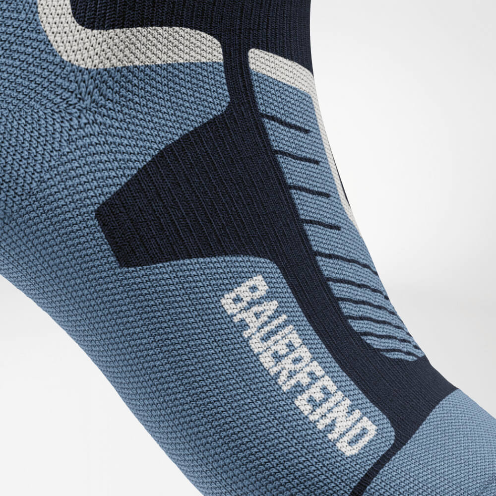 Close-up of the instep of a blue ski compression sock featuring reinforced knit pattern for optimal support and pressure distribution. Perfect for long days on the slopes.