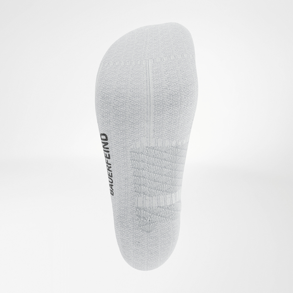 View of the sole of the white Run Performance Low Cut Socks by Bauerfeind showing visible comfort and compression zones around the midfoot.