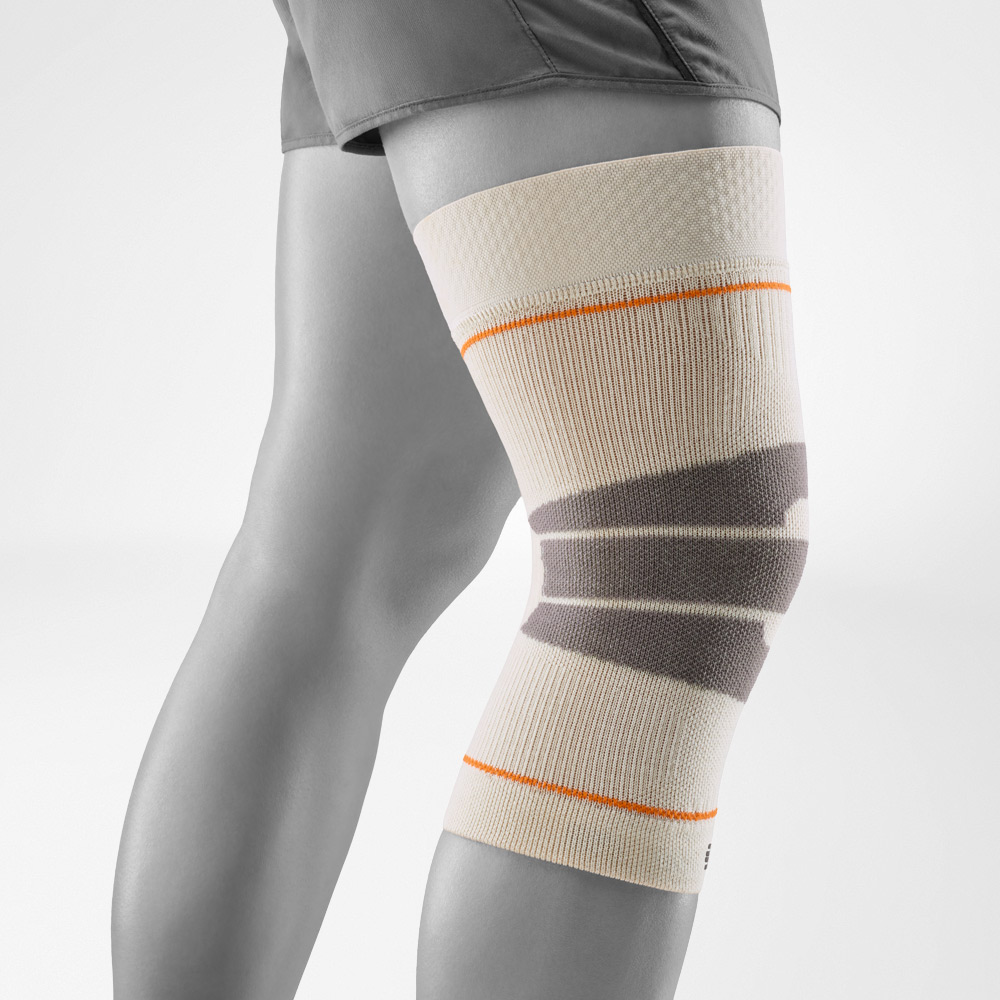 Sand-colored knee support for outdoor sports, shown in a studio side profile. The breathable knit ensures comfort and stability, perfect for hiking and running outdoors.