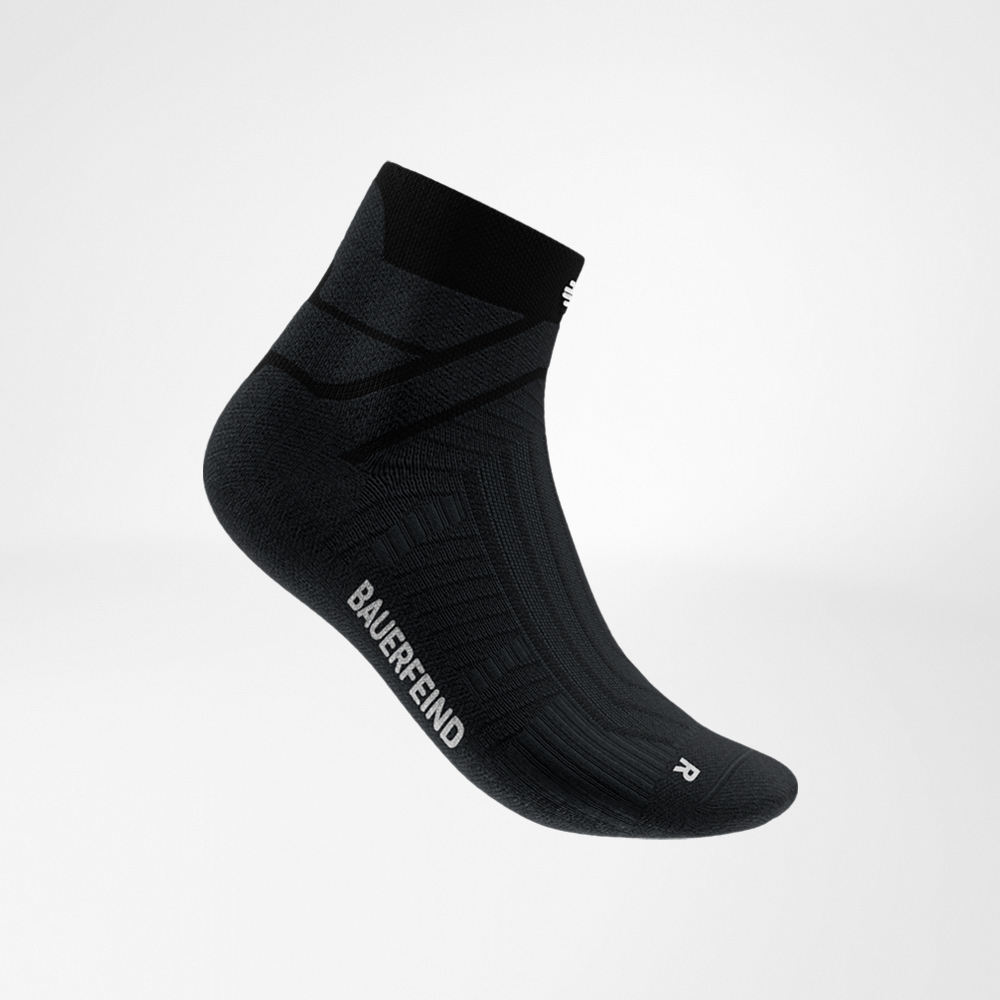 Black Run Performance Low Cut sock by Bauerfeind in a side view, highlighting the instep area, breathable knit structure, and the Bauerfeind lettering on the side.