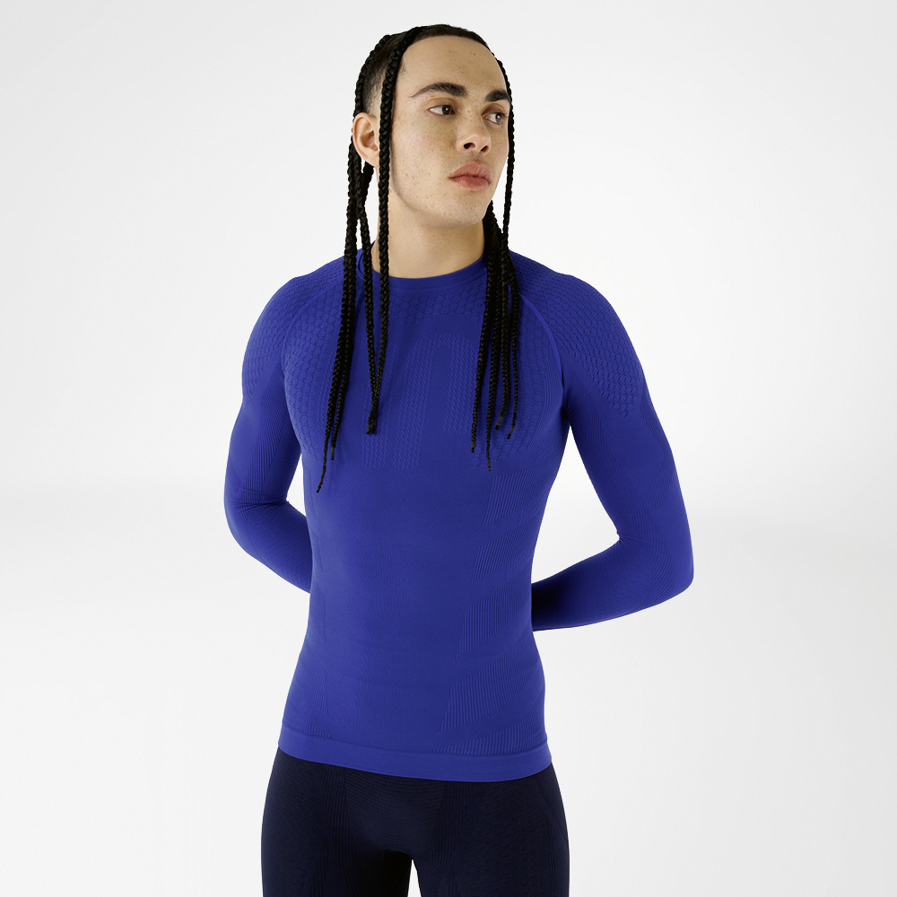 Front view of a man in a blue, close-fitting long sleeve shirt with textured design