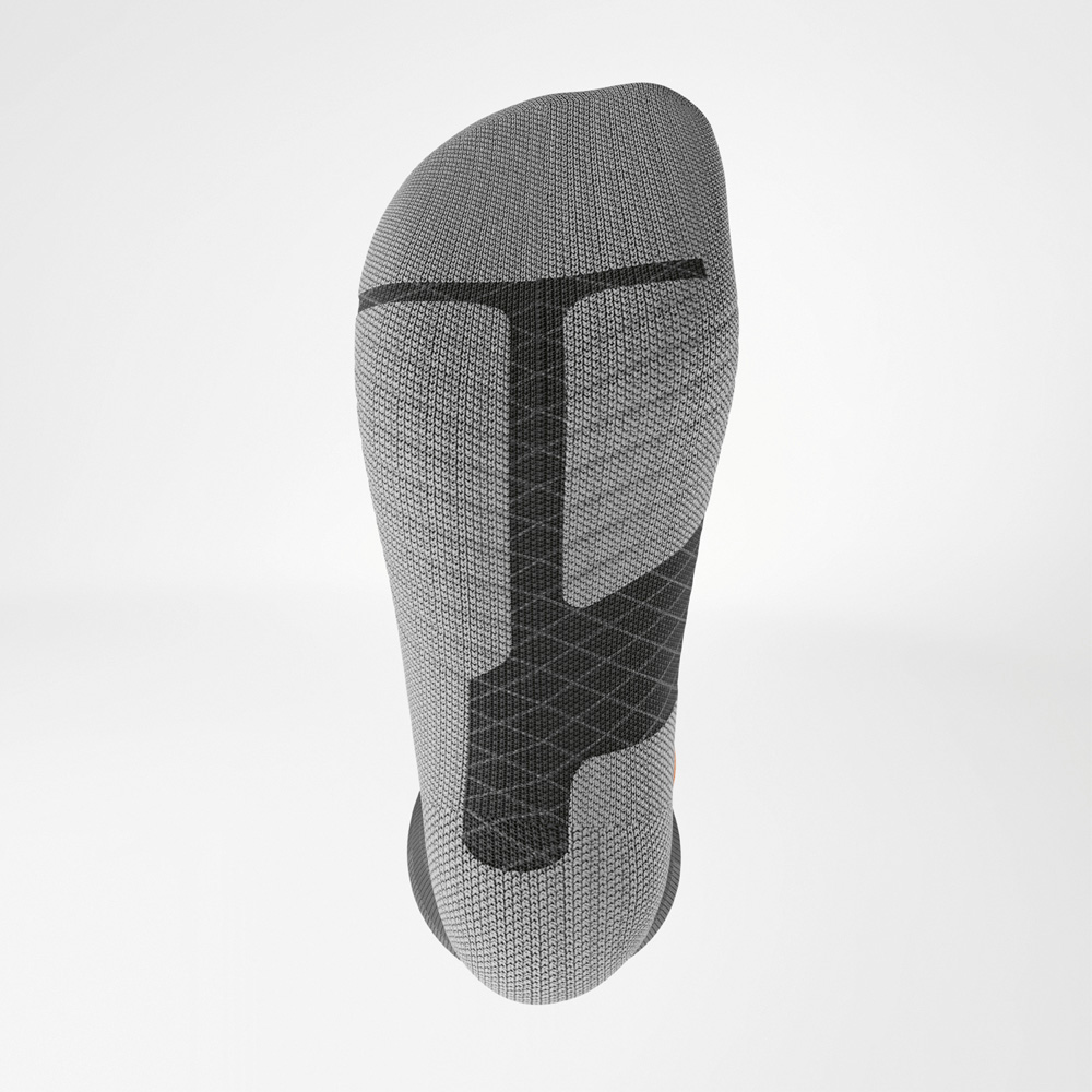 Grip and cushioning right where you need it Bottom view of the Ski Performance sock showing textured fabric and reinforced zones at toe and heel. The pattern indicates key pressure zones for support.