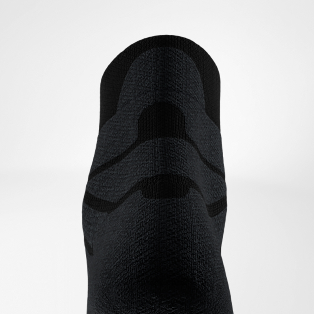Close-up of the back of a black sports sock showing the padded and structured Achilles tendon area for shock absorption and support during running.