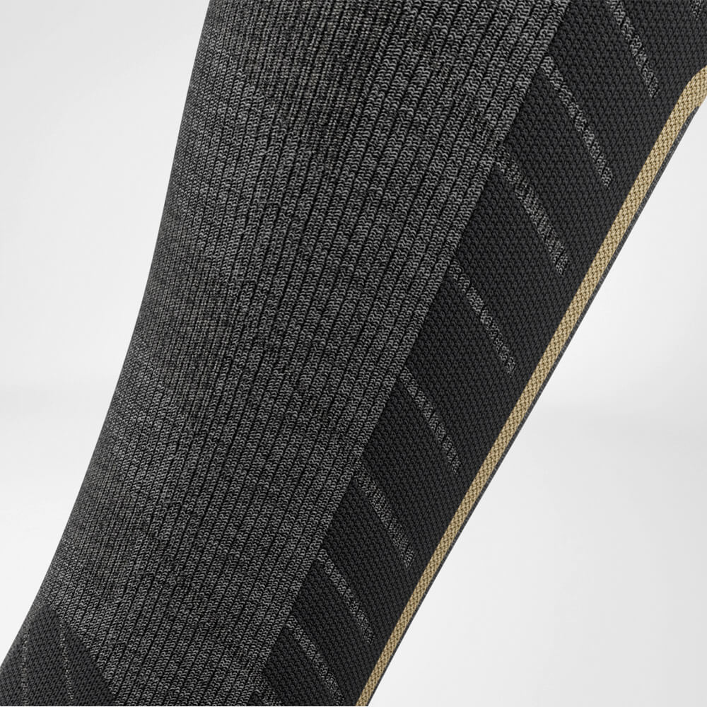 Detailed view of the calf compression zone of the grey sports sock for skiing with merino wool