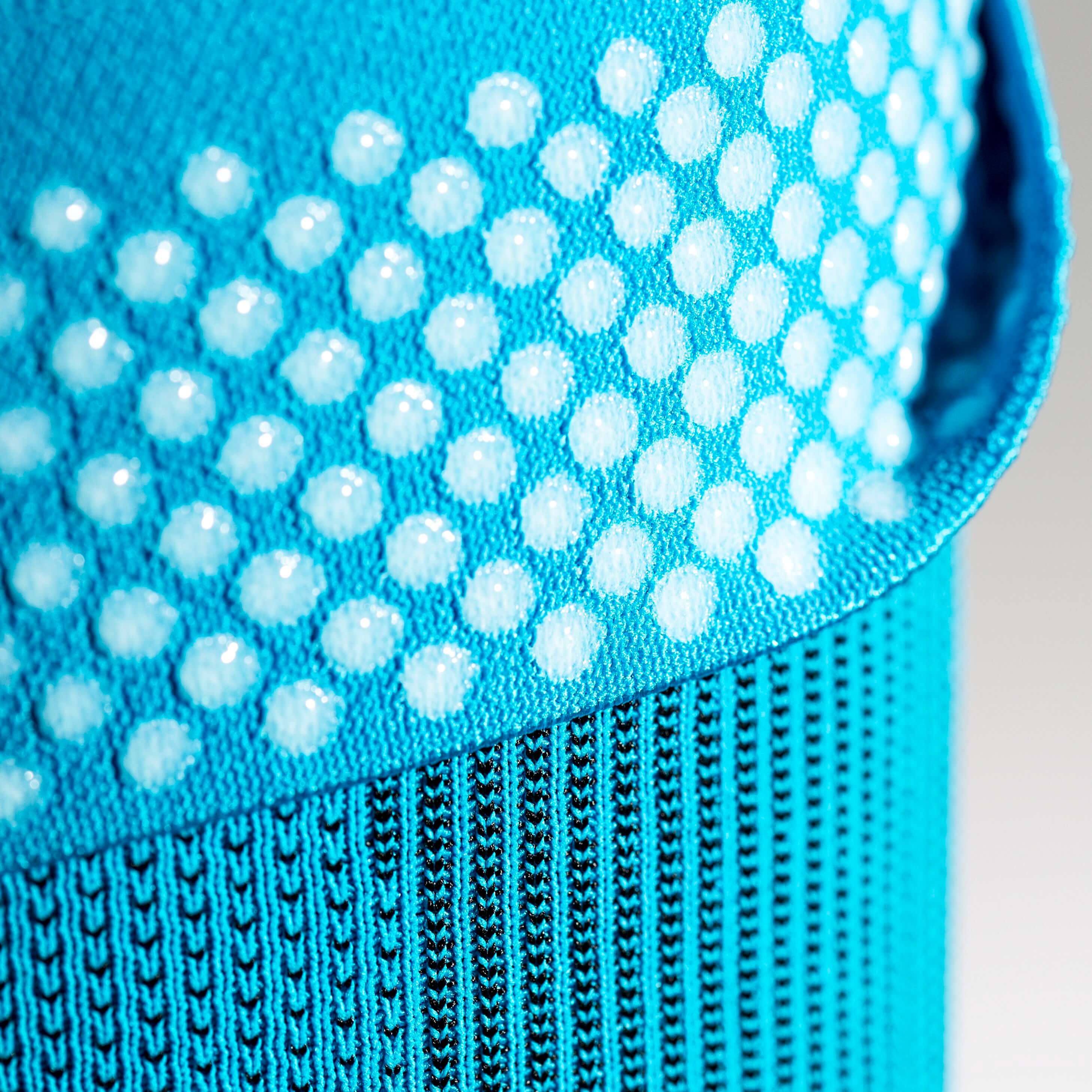 Detailed view of a blue Knee Sleeves with the upper part and view of the silicone healing nops