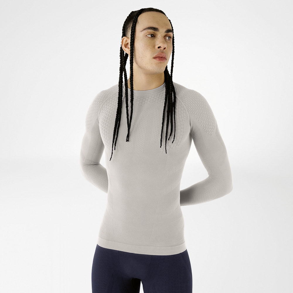 Front view of a man in a silver-grey, close-fitting long sleeve shirt with textured design
