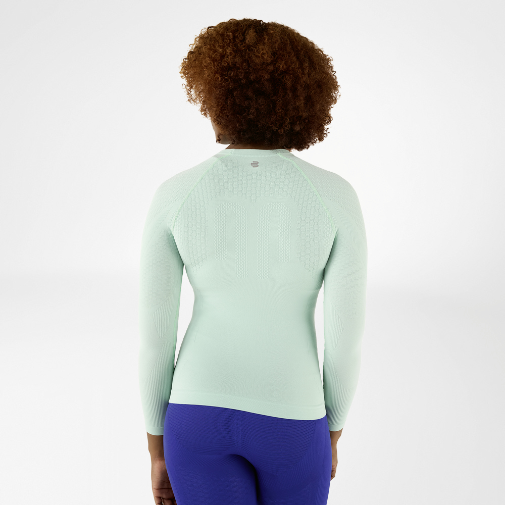 Back view of a light green, close-fitting long sleeve shirt with textured design