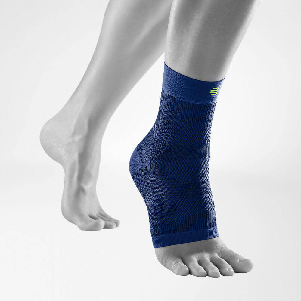 Compression Ankle Support Dark Blue front view diagonally Complete view of the dark blue compression Ankle Support on a stylized gray leg