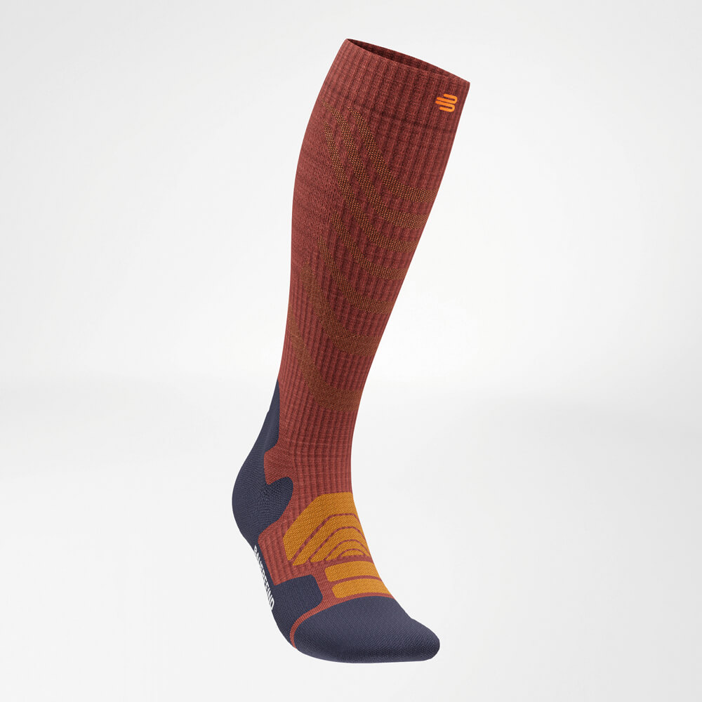 The Merino Outdoor Socks in Garnet in a diagonal front view from the left, highlighting the ergonomic fit and attractive color pattern.