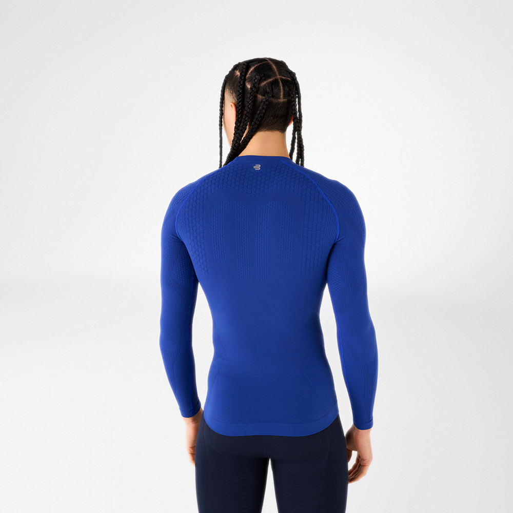 Back view of a man in a blue, close-fitting long sleeve shirt with textured design