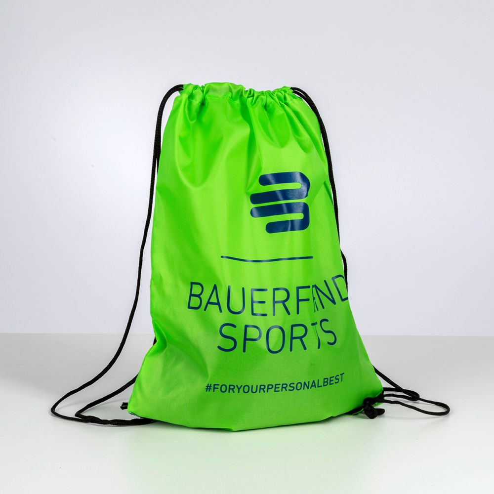 Studio shot of a green Bauerfeind Sports drawstring bag on a white background, featuring the logo and hashtag.