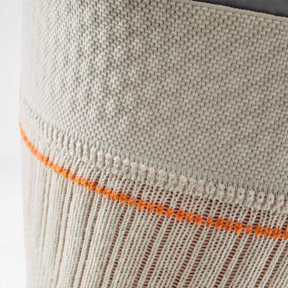 Close-up of the sand-colored knee support with orange contrast stitching. The detailed view highlights the breathable knit fabric at the upper edge, ensuring secure fit and comfort during outdoor activities.