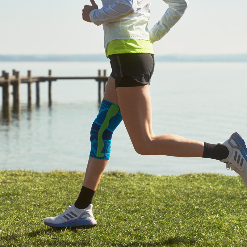 Anna Hahner runs on the lake with a blue knee band