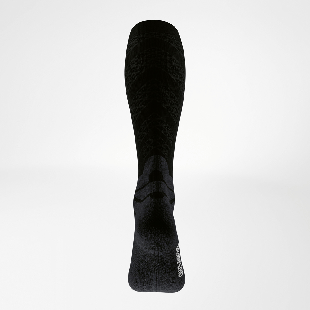 Rear view of a black running sock showing functional zones on the calf and heel, with fine compression structures for targeted muscle support.