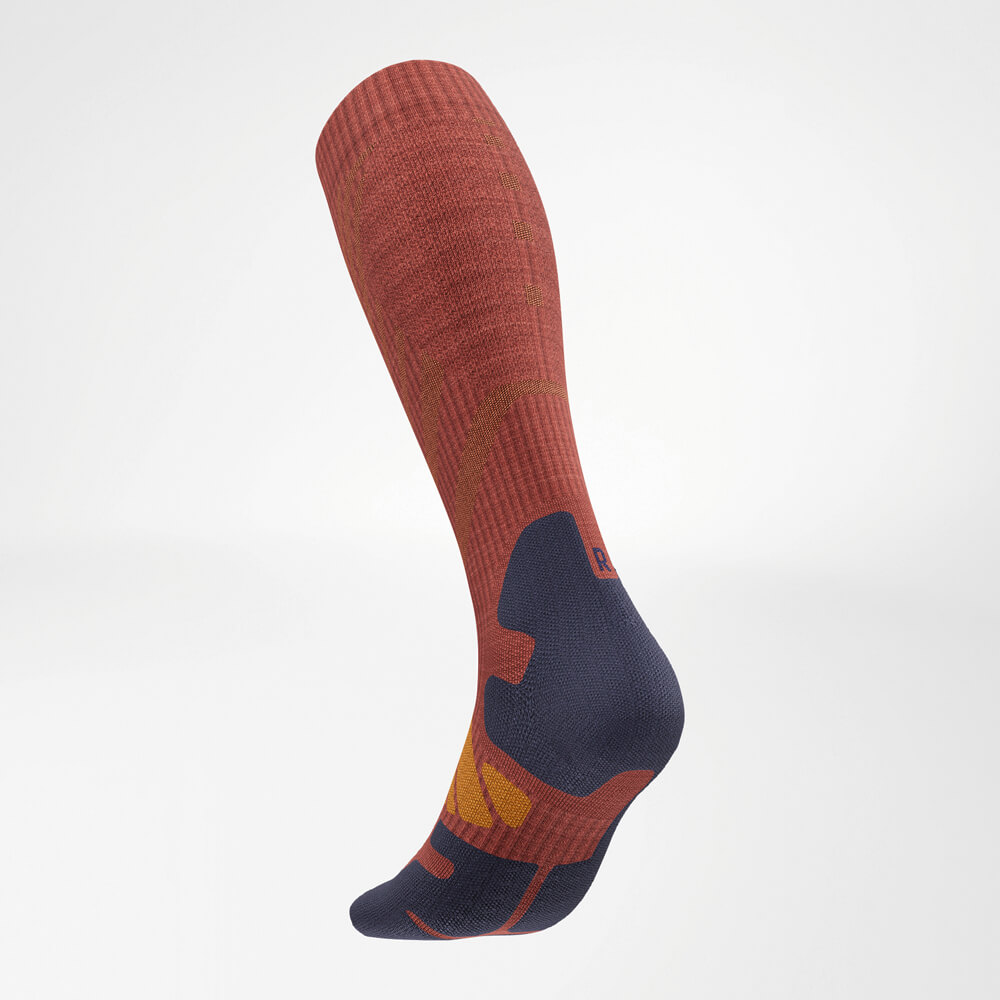 The Merino Outdoor Socks in Garnet in a diagonal rear view from the left, emphasizing the reinforced heel and shaft areas.
