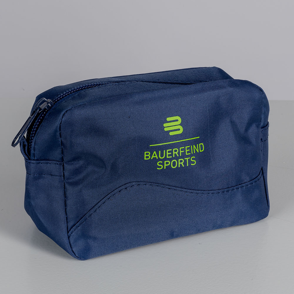 Close-up of a small, blue Bauerfeind Sports cosmetic bag in the studio. The bag is simple and displays the Bauerfeind logo in green.